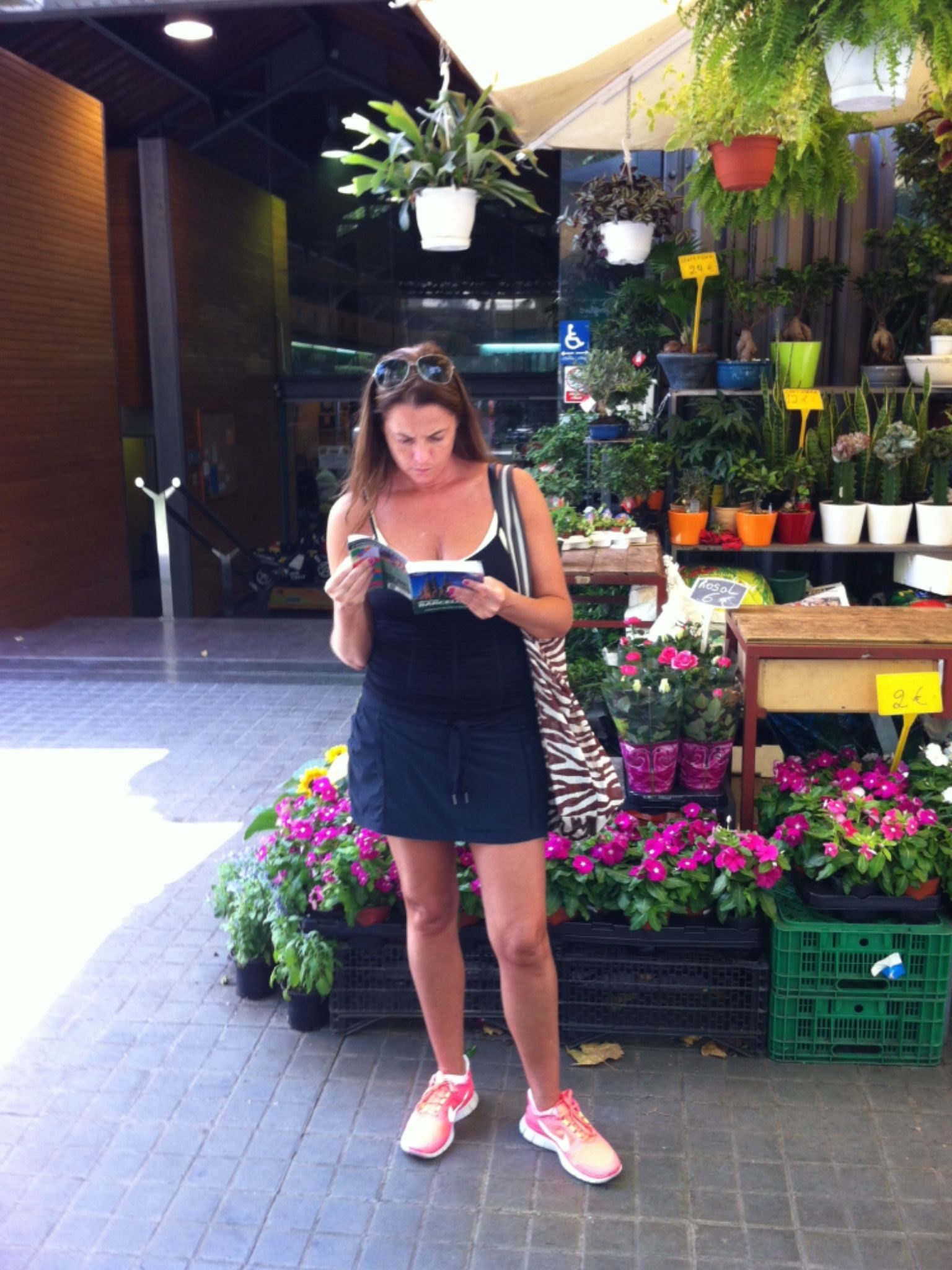 Ulana Rey PharmD at a flower-filled market stall in Barcelona.